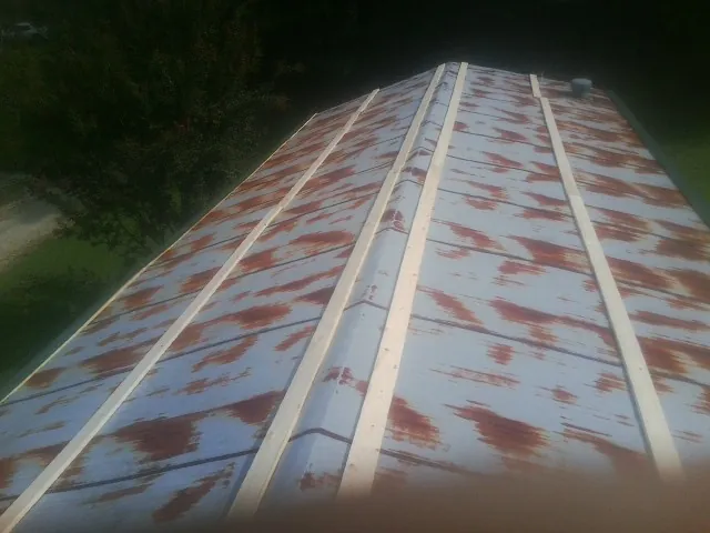 Rusted metal roof panels with new wood purlins before replacement — Storm Damage Roof Repair in Boyers by Roofing Brothers